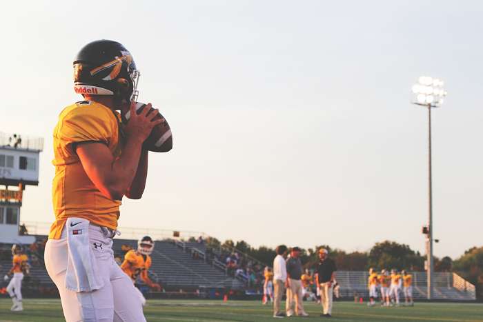 Amateur football player about to throw ball